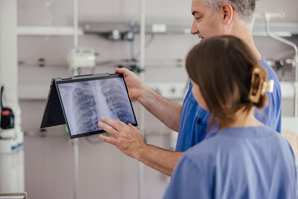 Medical team in simulated training watching medical images on a wireless device