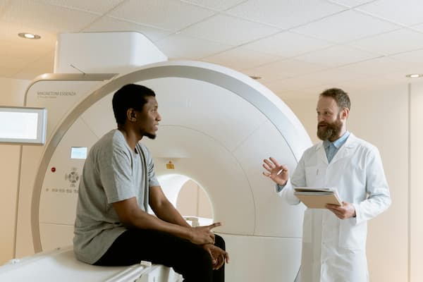 doctor and patient in front of a MRI device