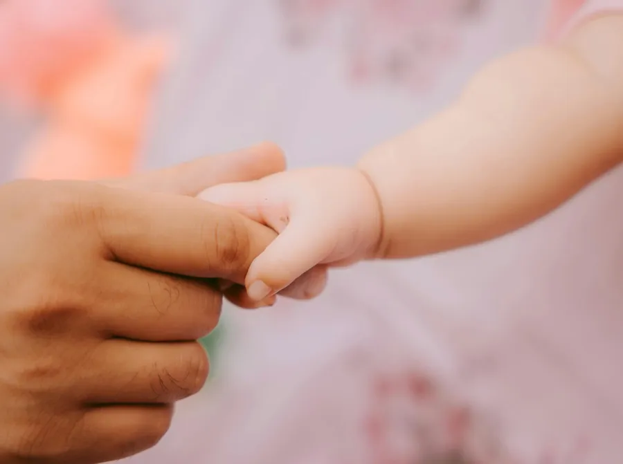 Baby holding finger