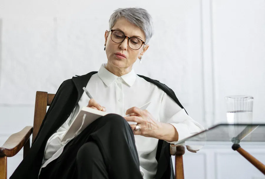 Coach taking notes during consultation