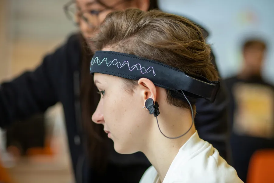Close-up of a woman wearing an EEG headband during a study